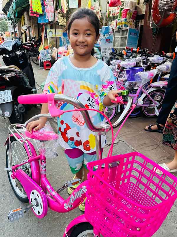 Nhy with her new bicycle.